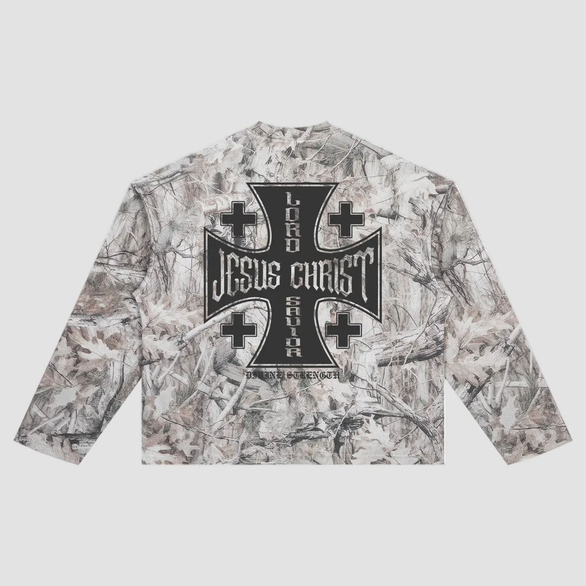 A long-sleeve crop top featuring a woodland camouflage pattern in shades of gray, beige, and brown, with a large black gothic-style cross graphic on the chest.